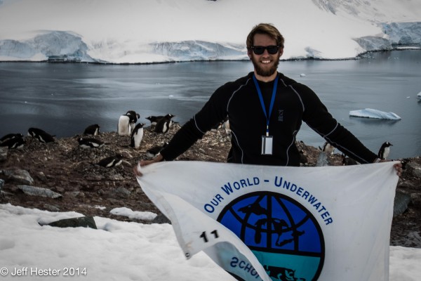 Standing in front of a penguin colony representing the Our World-Underwater Scholarship Society!